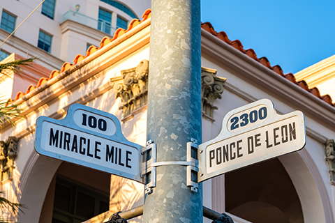 A stock photo of two street signs in Coral Gables, Florida.